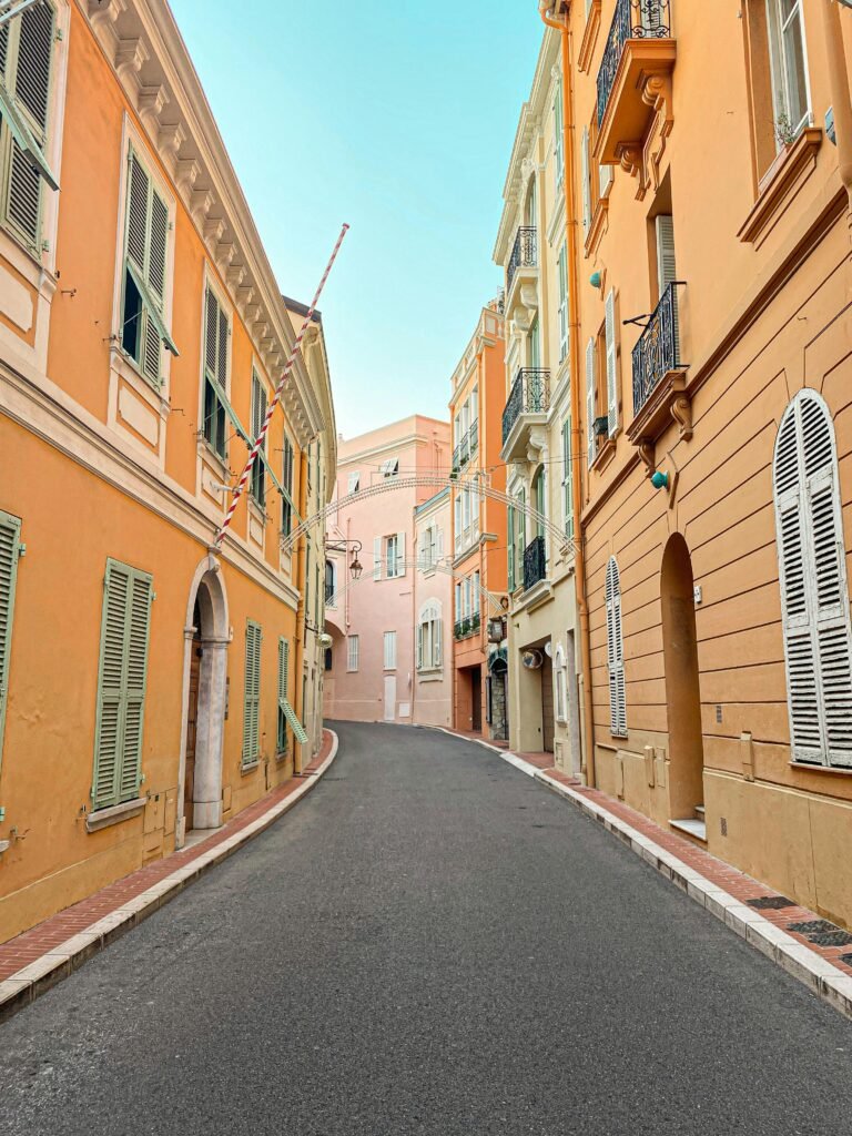 pexels-photo-11854106-11854106 Discover a picturesque alleyway in Monaco with colorful, historic buildings and vibrant architecture.